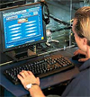 Person sitting in front of a computer at an Internet Cafe